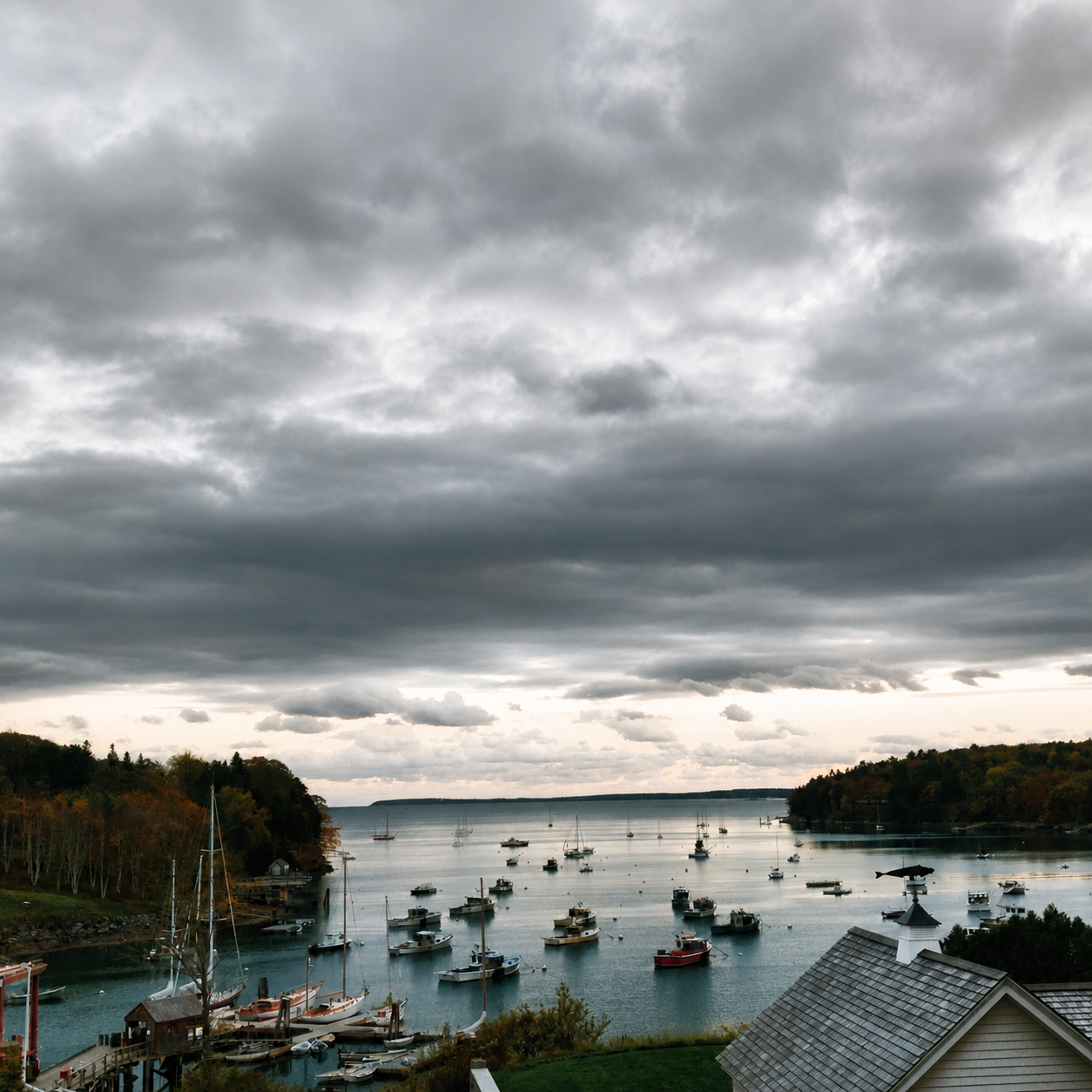 Boats gathered in a harbor beneath a dramatic cloud-filled sky