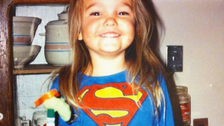 Jessica as a child wearing a Superman shirt